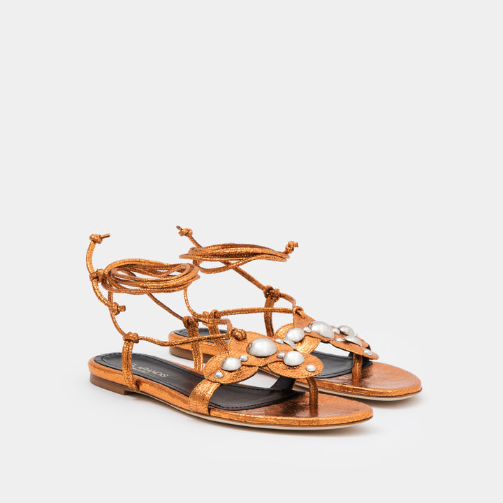 Copper crinkle metallic oversized studded flat thong with an ankle-tie